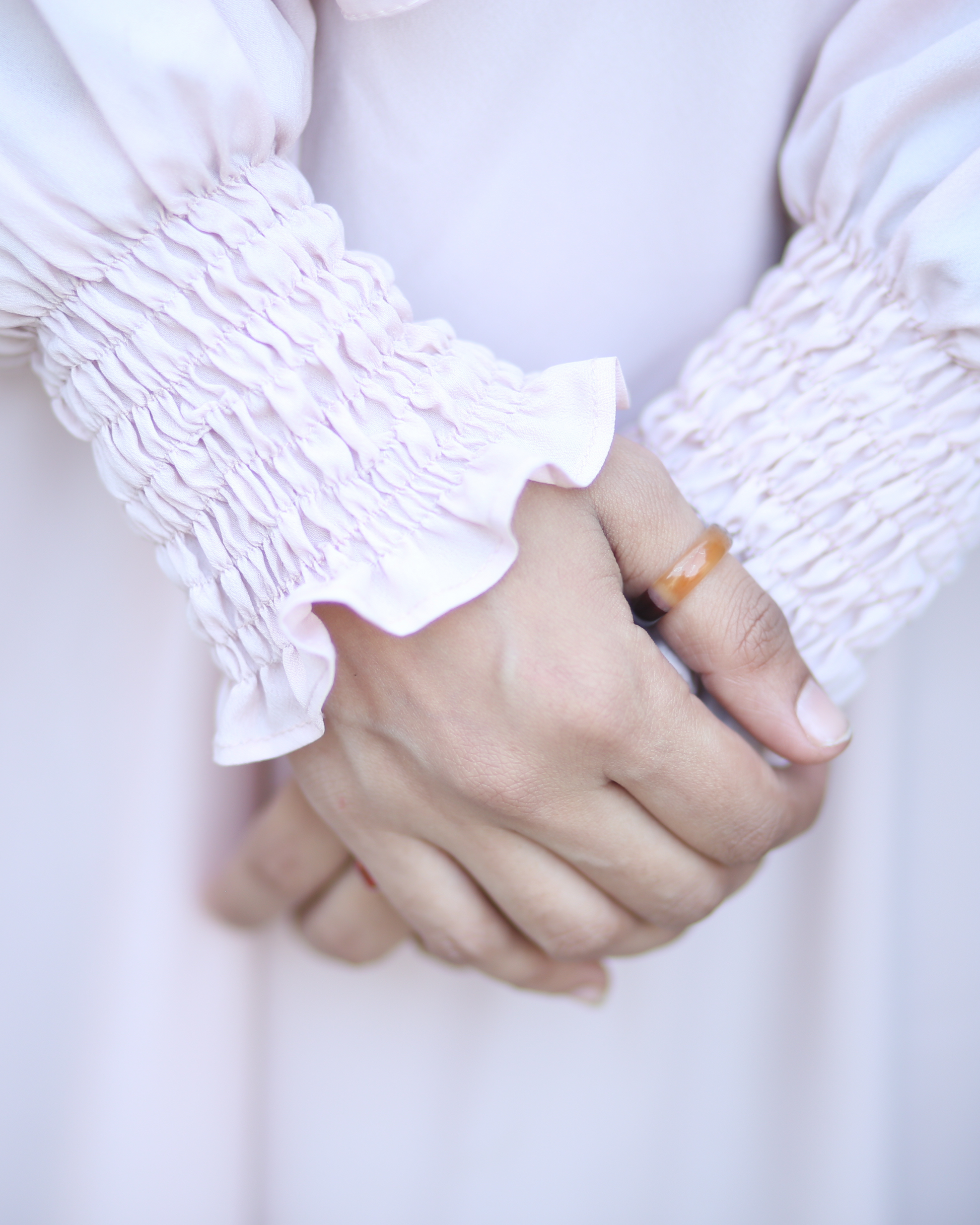 Close-up of light pink abaya with soft elastic sleeves - comfortable front-closed modest dress USA