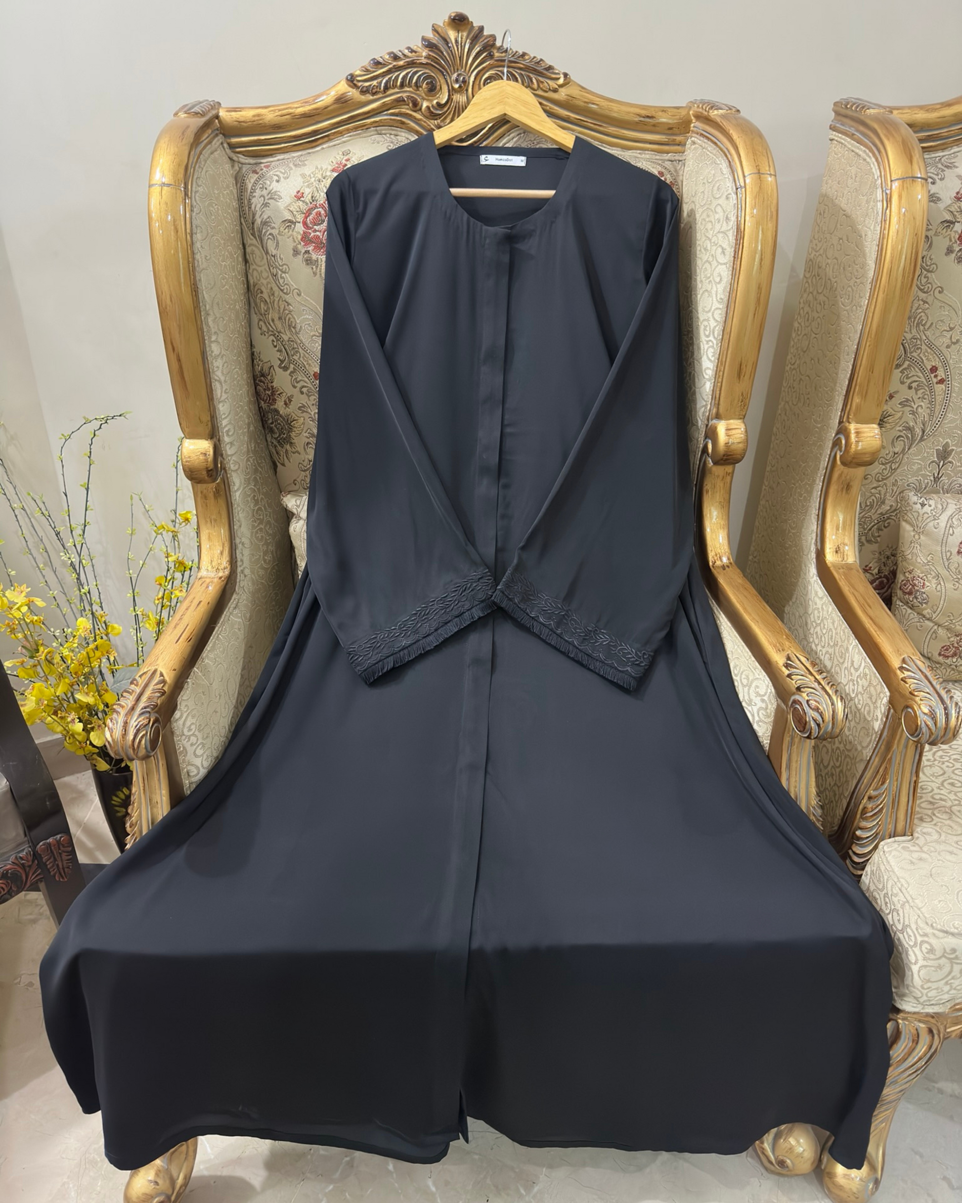 Detail of embroidered sleeves on black abaya - graceful modest dress with refined charm Michigan
