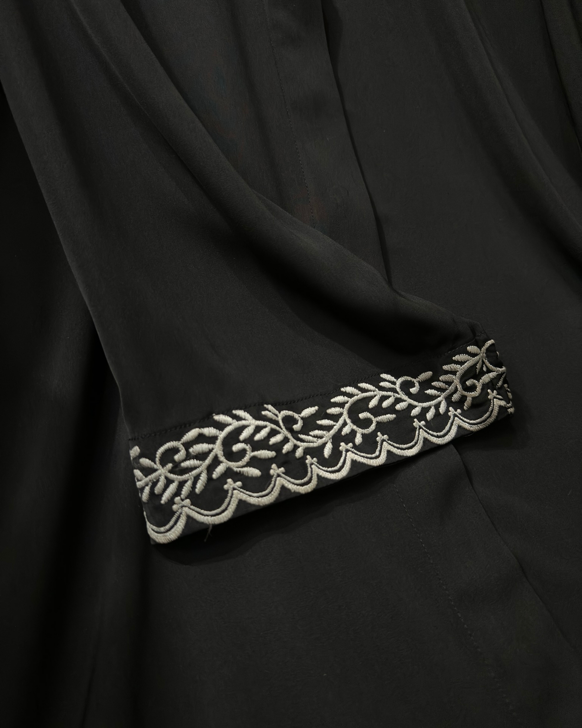Muslim woman wearing black abaya with intricate sleeve embroidery - elegant modest wear Michigan