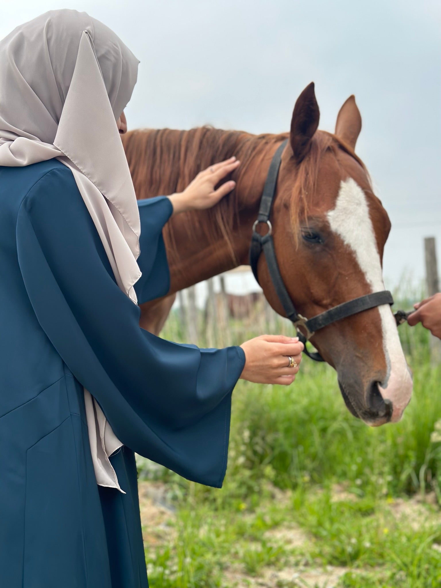 Close-up of Ocean Velvet Abaya wide sleeves with buttoned cuffs - elegant modest wear