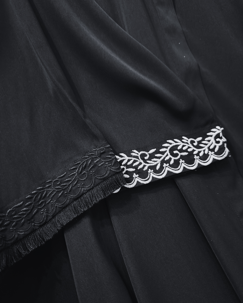 Close-up of pearl embroidery and black embroidery with fur-like lace detail on luxurious abaya sleeves - premium modest dress
